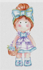Cross-stitched design of a girl with red hair, wearing a blue dress and ribbon in her hair, holding a basket.