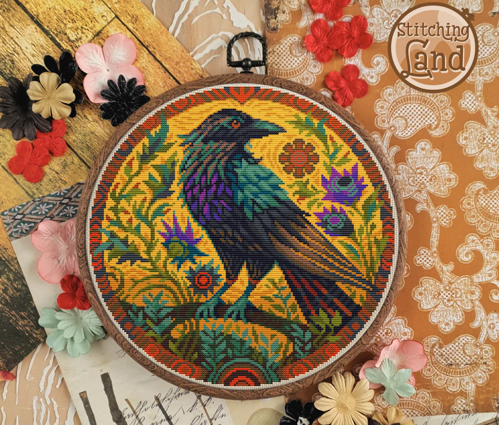 Stamped cross stitch design of a colorful crow design surrounded by flowers on a textured background.