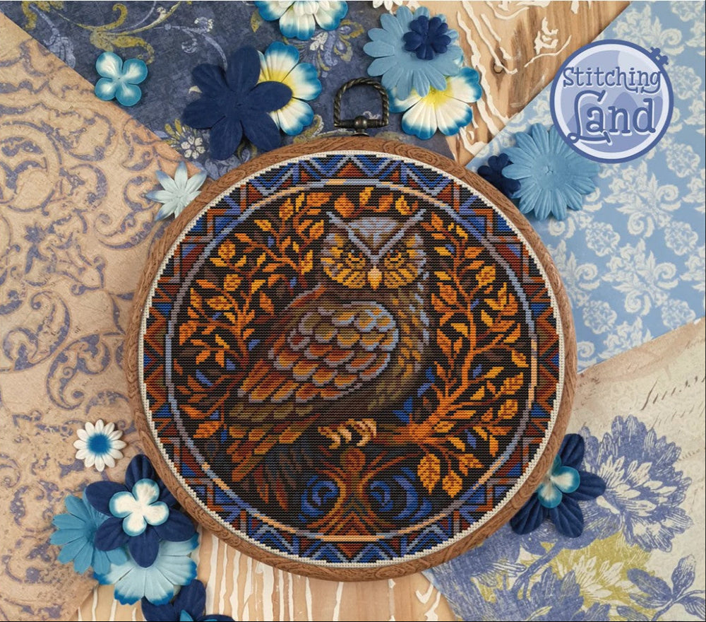 Stamped cross stitch design of a owl design on a floral and paisley patterned fabric.