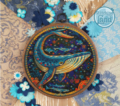 Stamped cross stitch design of a whale design surrounded by decorative flowers and 'Stitching Land' branding.