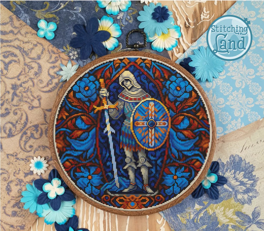 Stamped cross stitch design of a skeleton, sword, and shield, surrounded by flowers on a patterned background.