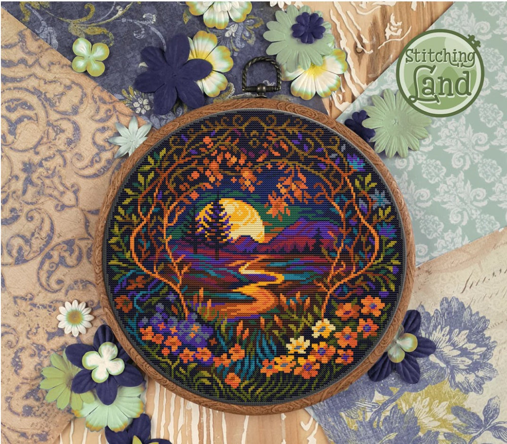 Stamped cross stitch design of a colorful landscape design surrounded by flowers on a textured fabric background.