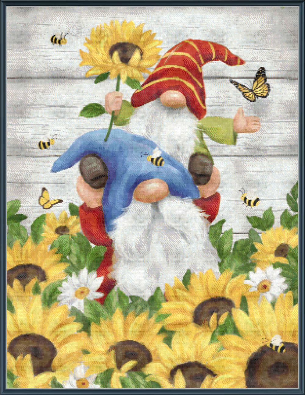 Two gnomes among sunflowers with a wooden background