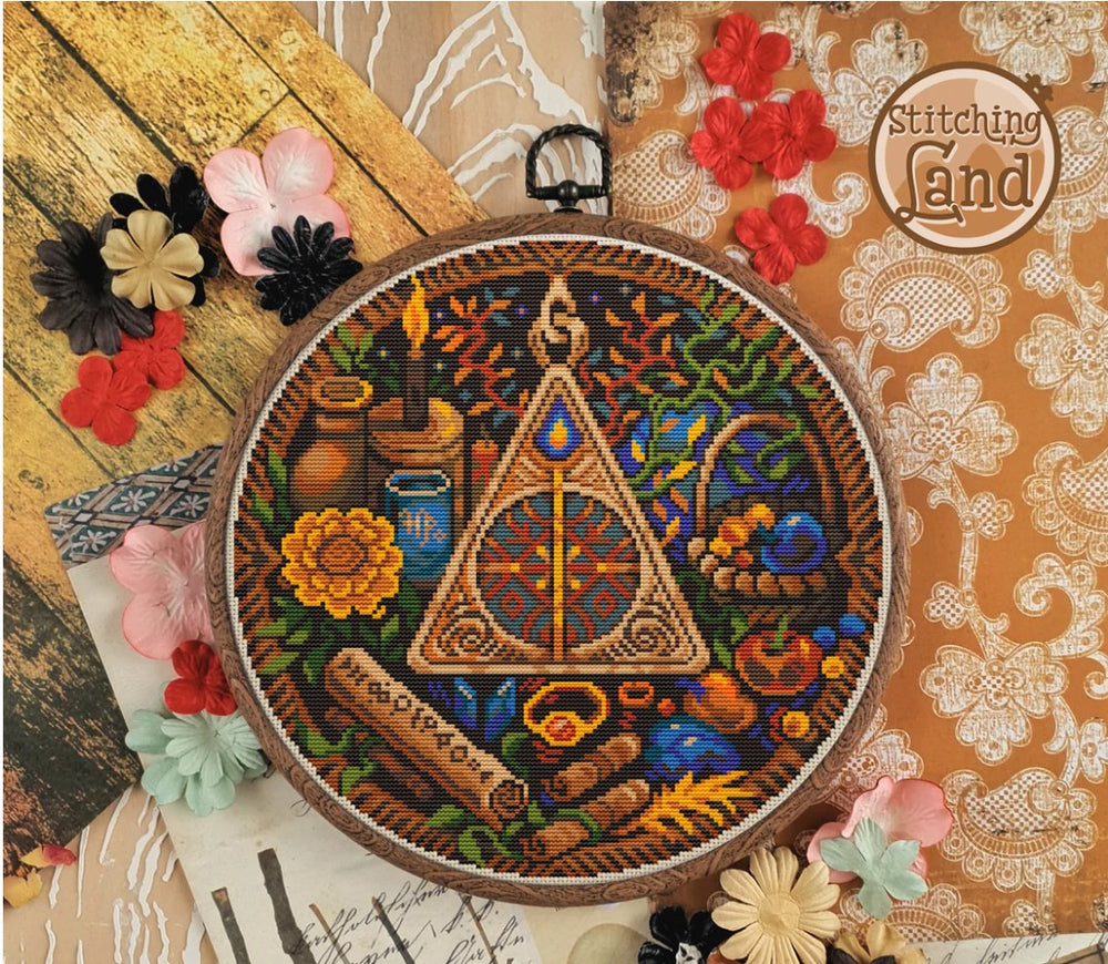 Stamped cross stitch design of a triangle and floral elements, surrounded by decorative flowers on a textured background.