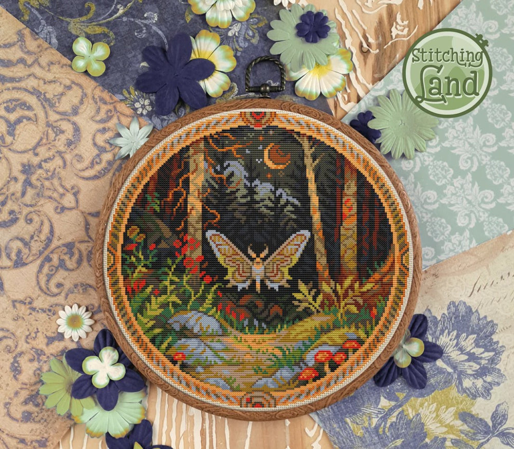 Stamped cross stitch design of a moth design on a textured fabric background,