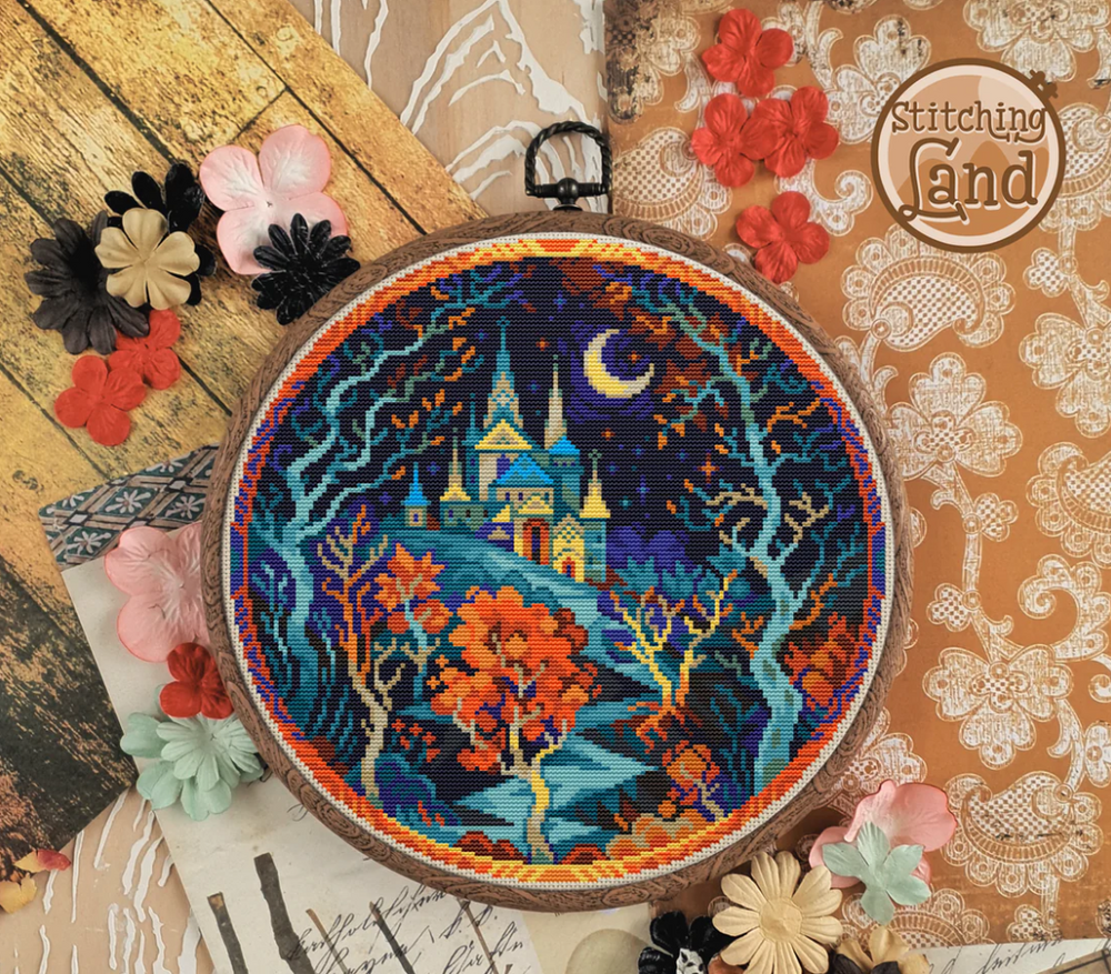 Stamped cross stitch mockup of a Embroidery hoop with a colorful castle design on a textured surface with flowers.