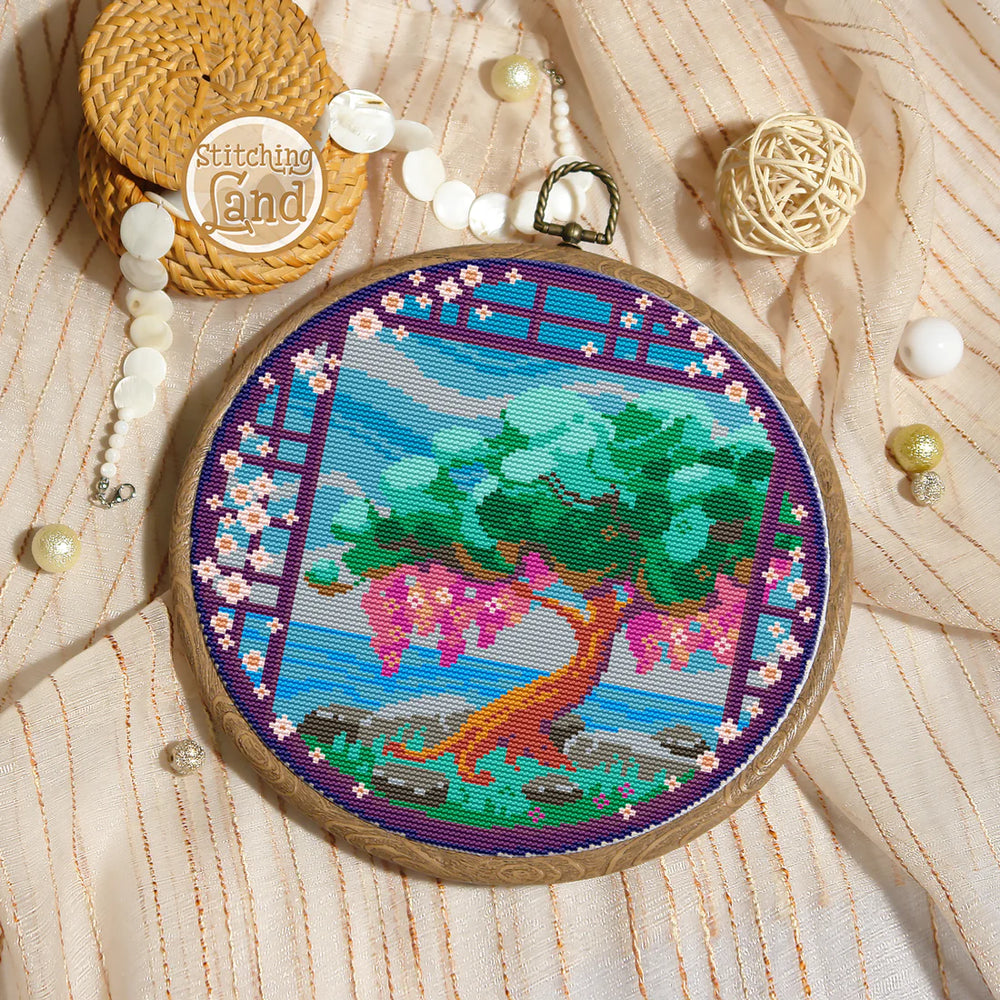Stamped cross stitch mockup of a Embroidery hoop with colorful tree design on a textured fabric background