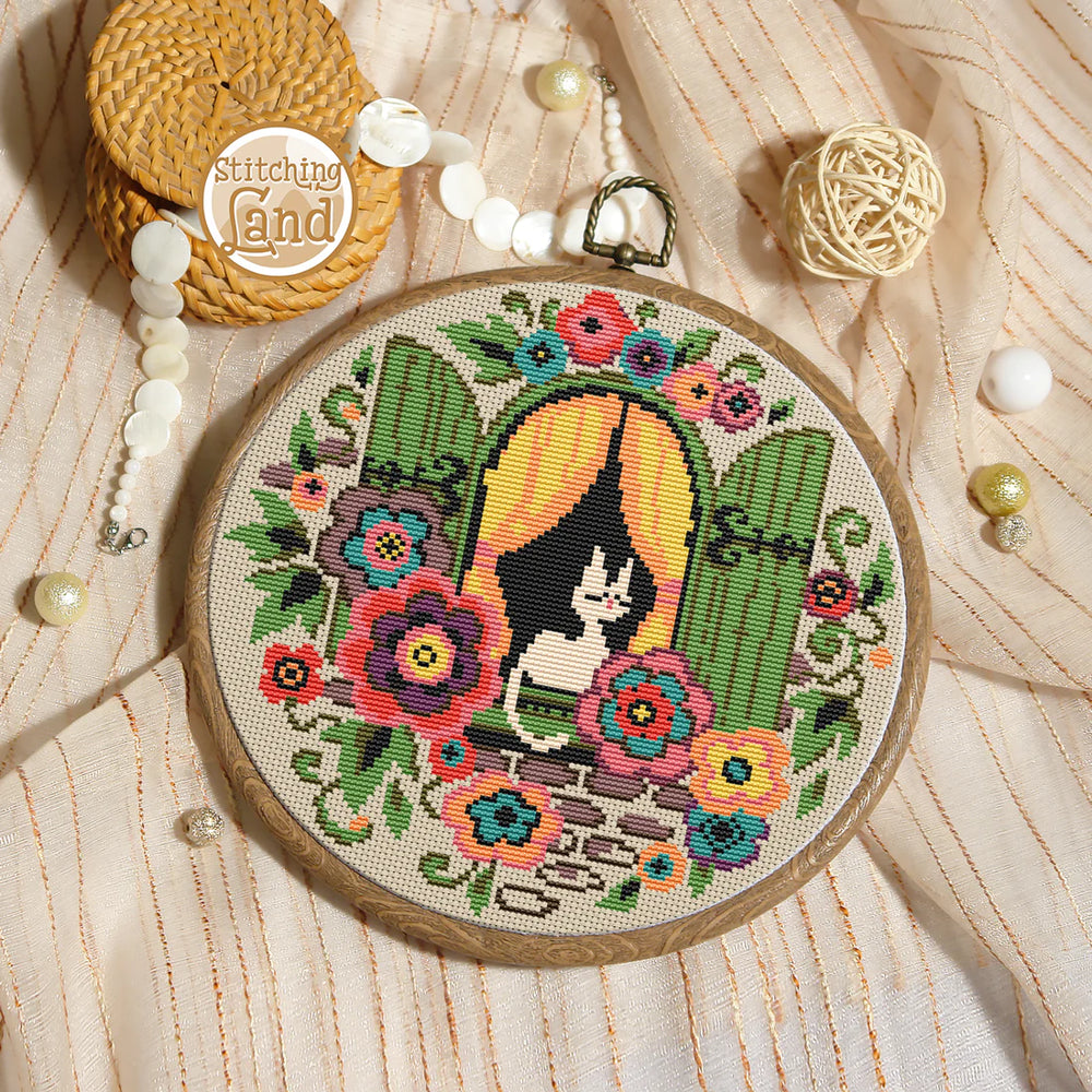 Stamped cross stitch mockup of a Embroidery hoop with a cat and flower design on a textured fabric background