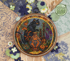 Stamped cross stitch design of h a black cat design surrounded by flowers and patterns