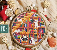 Stamped cross stitch mockup of a Embroidery hoop with a colorful pattern of cats and books, surrounded by decorative items on a textured surface.