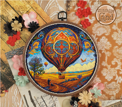 Stamped cross stitch mockup showing a Embroidery hoop with a colorful hot air balloon design on a decorative background with flowers and lace.