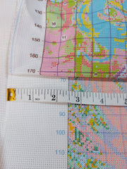 Comparison of The Stamped Stitch Club's premium stamped cross stitch fabric with a cheaper alternative. A measuring tape highlights our generous fabric borders and professionally serged edges, which prevent fraying and provide ample space for stitching frames and finished framing. The cheaper alternative has narrow borders and unfinished edges that are prone to fraying.