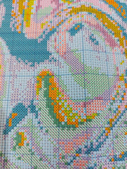 Close-up of The Stamped Stitch Club's premium stamped cross stitch fabric, showing crisp, clearly printed symbols in a variety of colours, shapes and patterns. Each symbol is designed to be easily distinguishable from the others, making the chart easier to read and follow while stitching.
