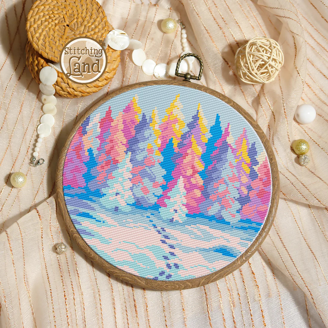 Stamped cross stitch mockup showing a  Embroidery hoop with colorful forest design on a textured fabric background